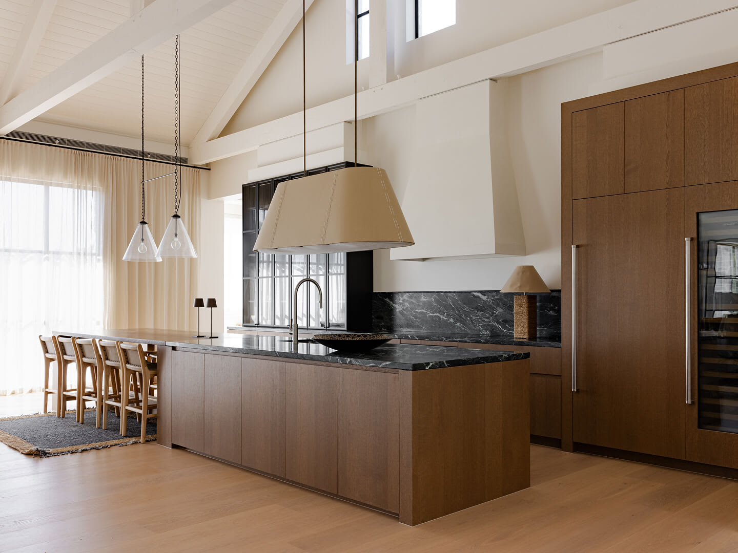Red Hill home kitchen with Bayonne veneer cabinetry and joinery complemented by matching timber flooring.